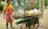 Thai Street Vendor Prepares Charcoal Barbecue Traditional Sausage