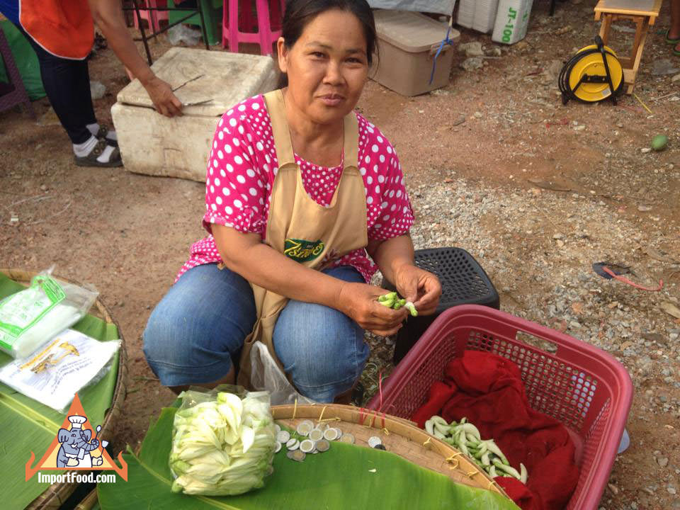 Market Vendor Prepares Sesbania Flower