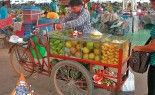 Thai Street Vendor Offers Fresh Fruit from a Bicycle Cart