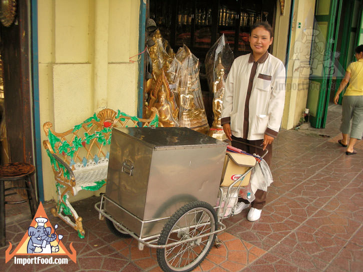 Thai Street Vendor Offers Yakult Sour Milk from a Push Cart