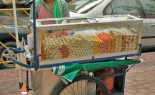 Thai Street Vendor Offers Assorted Deep-Fried Meatballs from a Push Cart